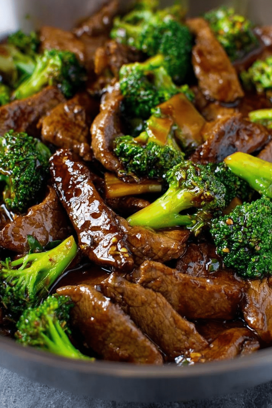 Delicious beef and broccoli stir fry served on a plate with rice and sesame seeds.